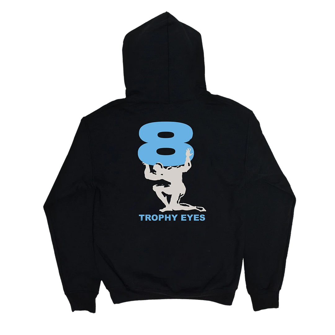 A black 100% cotton Trophy Eyes hoodie with a large light blue number 8 on the back. Below, a white silhouette holds the 8, and "TROPHY EYES" appears in blue underneath.