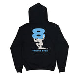 A black 100% cotton Trophy Eyes hoodie with a large light blue number 8 on the back. Below, a white silhouette holds the 8, and "TROPHY EYES" appears in blue underneath.