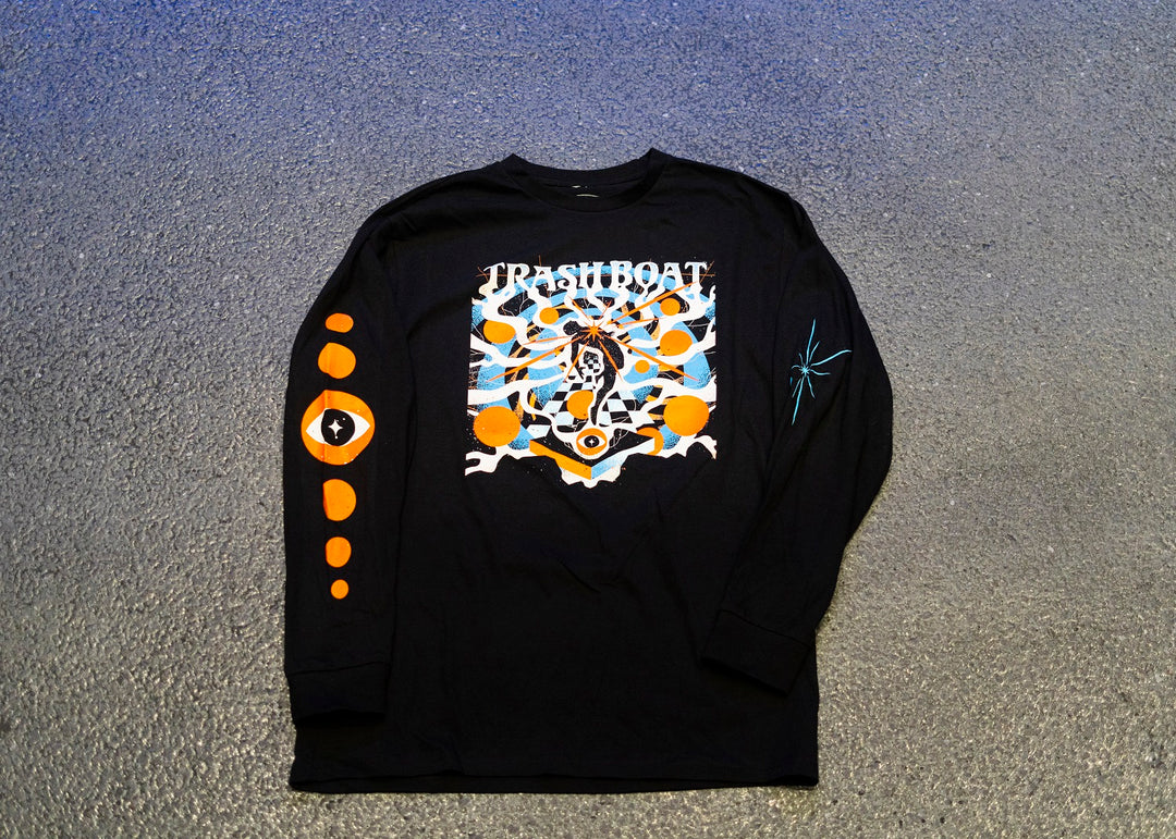 This Trash Boat long sleeve shirt features bold TRASH BOAT text, a vibrant graphic, orange eyes on the right sleeve, and a teal starburst on the left—an essential for fans of the brand.