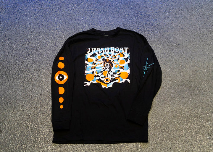 This Trash Boat long sleeve shirt features bold TRASH BOAT text, a vibrant graphic, orange eyes on the right sleeve, and a teal starburst on the left—an essential for fans of the brand.