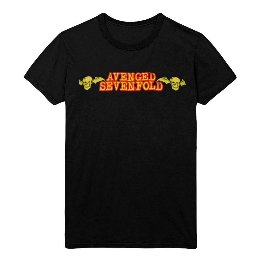 Black tee on a white background. Chest print has gold with red border text that reads Avenged Sevenfold in between two black & gold skulls with bat wings. 