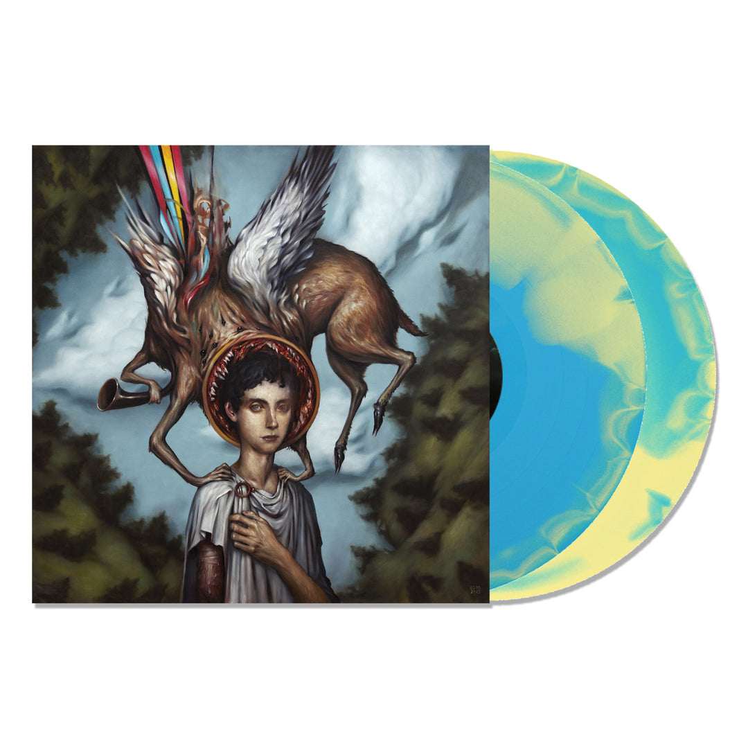 A limited edition Circa Survive vinyl with a blue and yellow marbled pattern sits by its cover, showcasing surreal art of a haloed figure and winged deer with rainbow beams, capturing the dreamlike vibe of Blue Sky Noise.