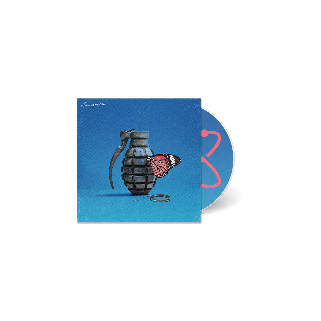 A CD case by Between You And Me features a blue cover with a grenade and butterfly, hinting at Armageddon. The partly visible CD displays a pink design on gray, complementing the explosive imagery and suggesting an intense soundtrack.
