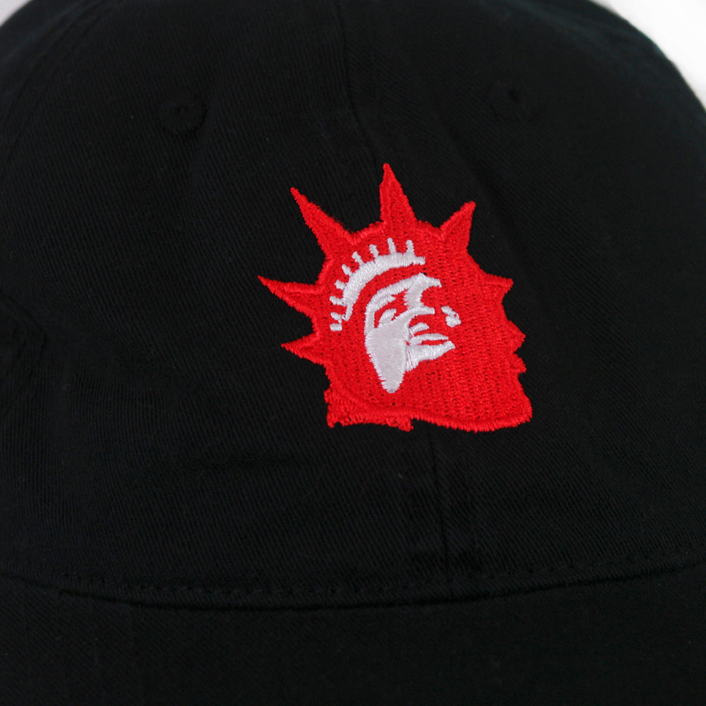 A close-up of a black fabric surface with an embroidered red and white Liberty Red Logo, resembling the Statue of Liberty, by Trophy Eyes—perfect for any Black Dad Hat.