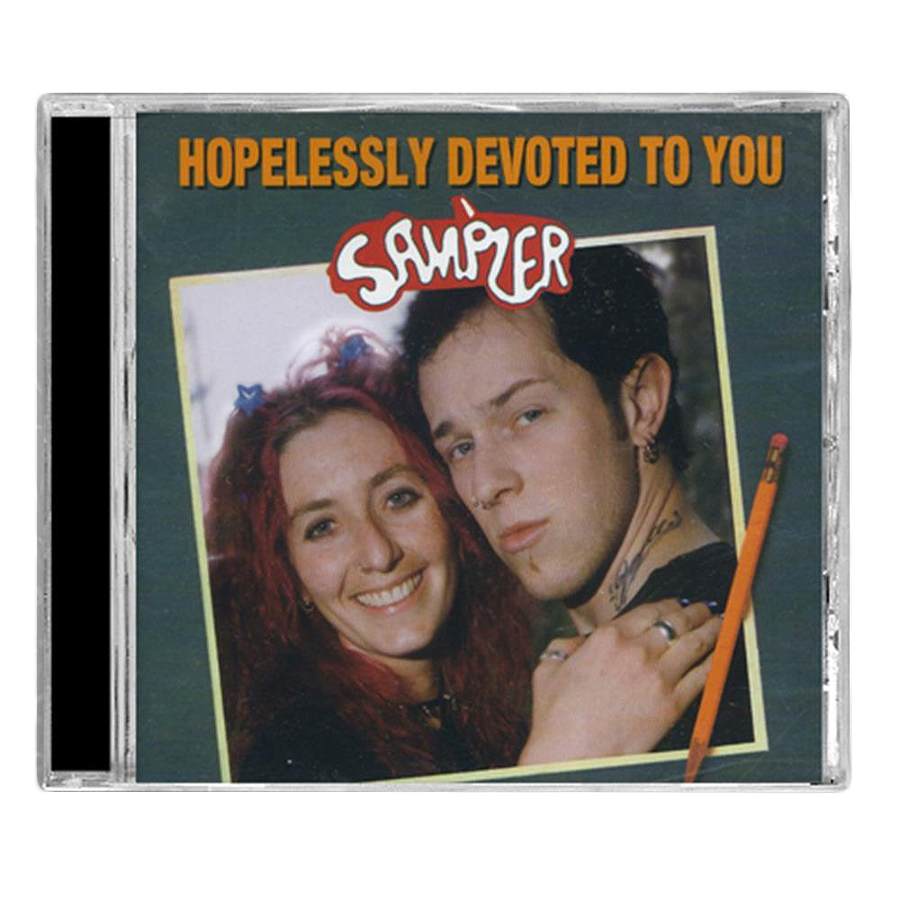 CD cover with two people close together, one smiling, one neutral. “Hopelessly Devoted To You” is at the top, and Sampler in playful script—an iconic Punk Compilation from Various Artists by Hopeless Records.