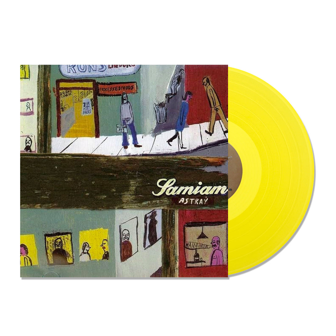 A limited edition Samiam Astray Yellow LP partially slides out of its album cover, which shows illustrated people on a street and at windows. The white script album title and tracklisting details appear on the artwork. Brand: Samiam.