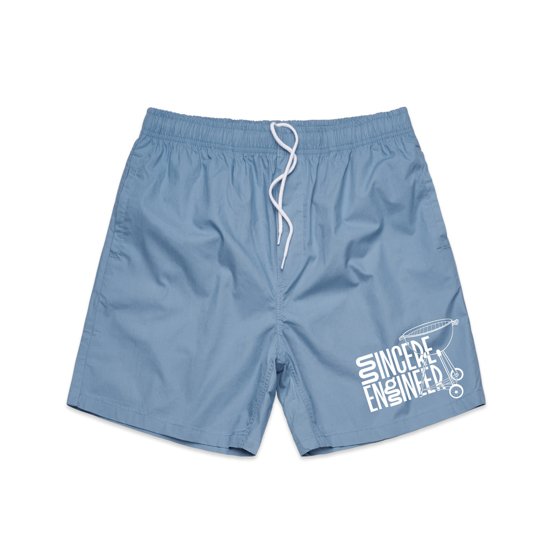 Sincere Engineer Carolina Blue ASColour beach shorts with a white drawstring, Sincere Engineer in stylized text on the left leg, and a small guitar headstock graphic.