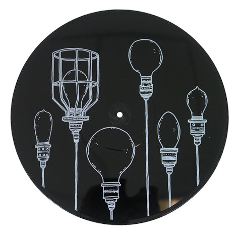 A black circular item from Dryjackets Lights Locks &amp; Faucets collection features white line drawings of six uniquely designed light bulbs arranged vertically across its surface.