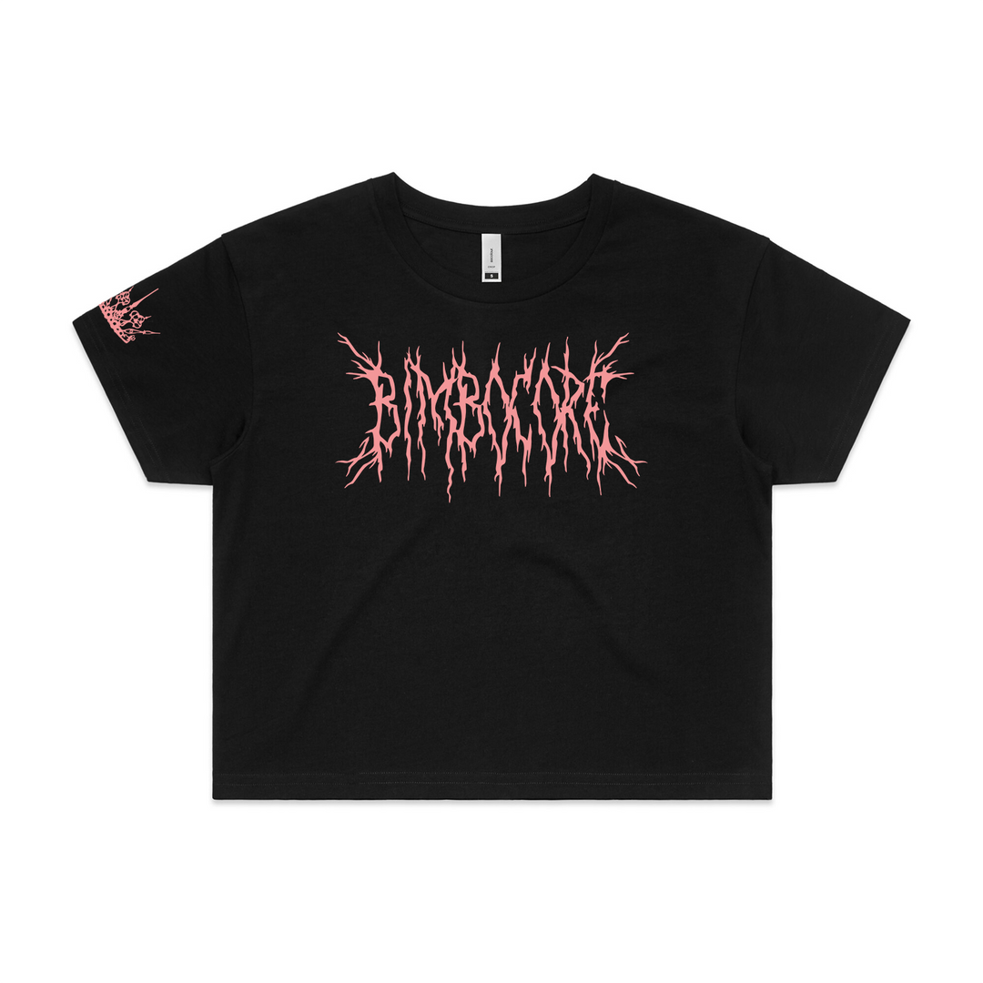 black cropped womens tee on white background. pink chest print that says bimbocore and a print on bottom right sleeve in pink of a crown
