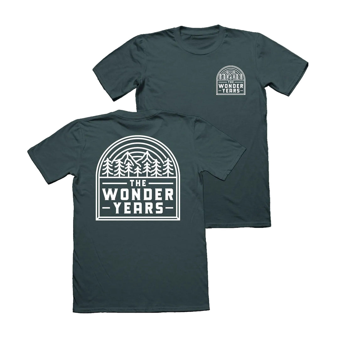 Two Forest Green T-shirts by The Wonder Years with white pine trees and sunset graphics. Small logo on chest, large THE WONDER YEARS design on back, inspired by Washington Square Park.