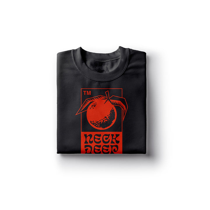 A folded black Neck Deep t-shirt made from 100% cotton, featuring a bold orange fruit with leaves graphic and stylized NECK DEEP text on the front.